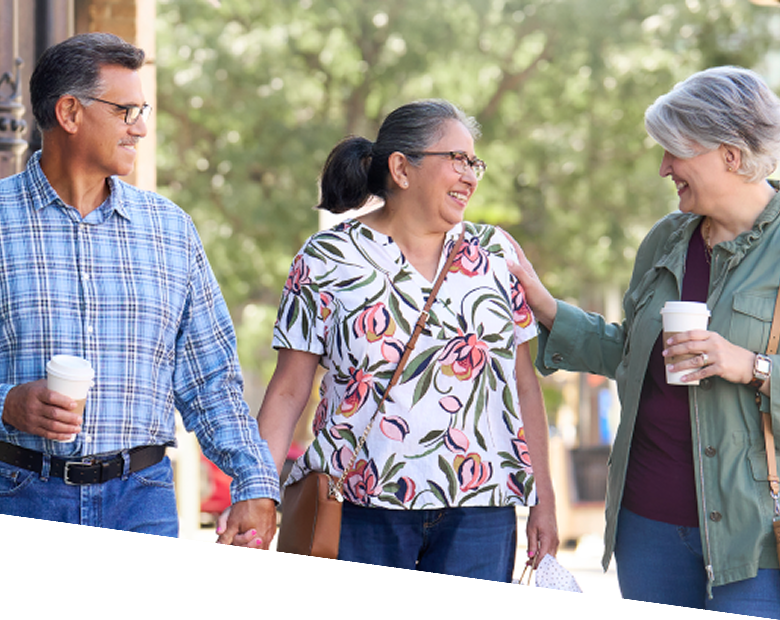 Three adults walking outdoors