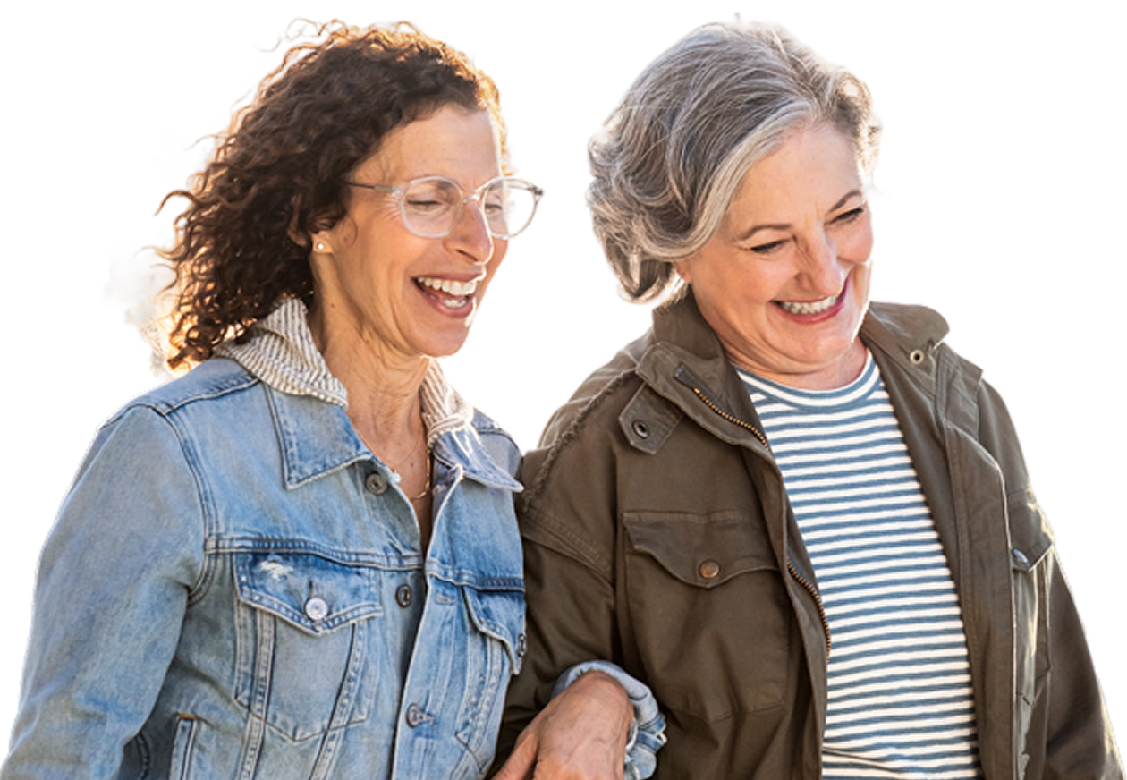 Two women laughing together while walking outside